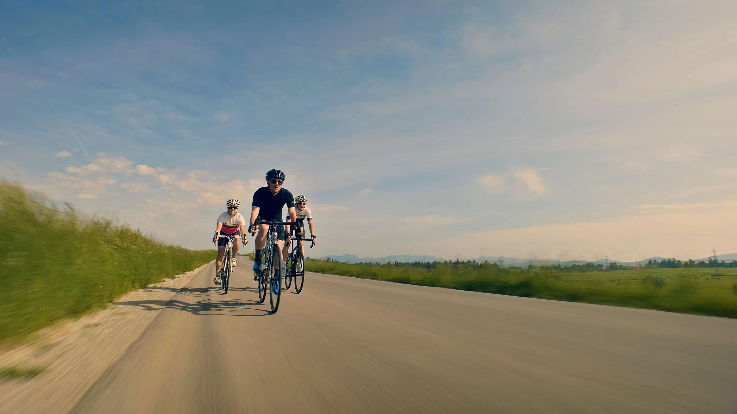 Riders traveling together on a scenic country road
